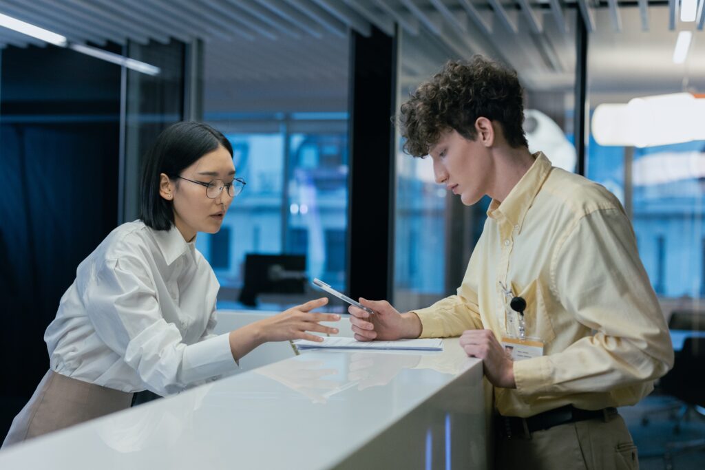 Receptionist guiding a person through a document