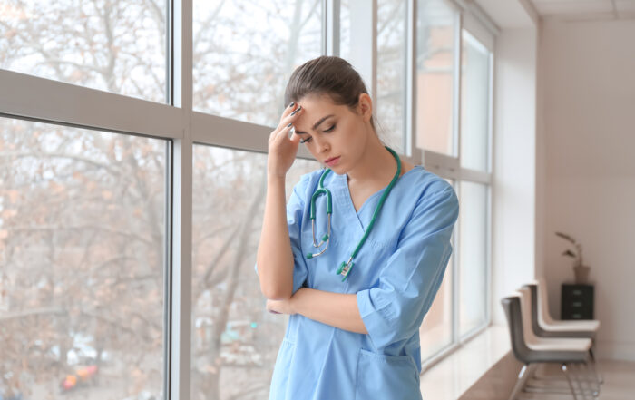 Photo of a Depressed Female Doctor in a Clinic