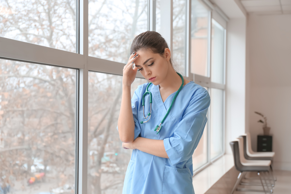 Photo of a Depressed Female Doctor in a Clinic