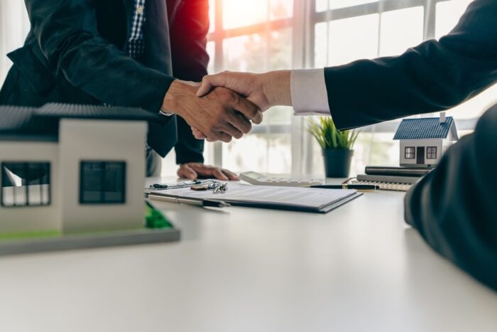 Closeup of a property manager shaking hands with their client