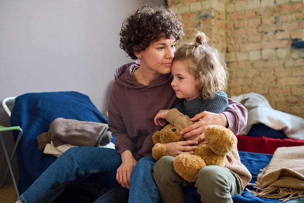 A candid photo of a mother and her child in a homeless shelter.