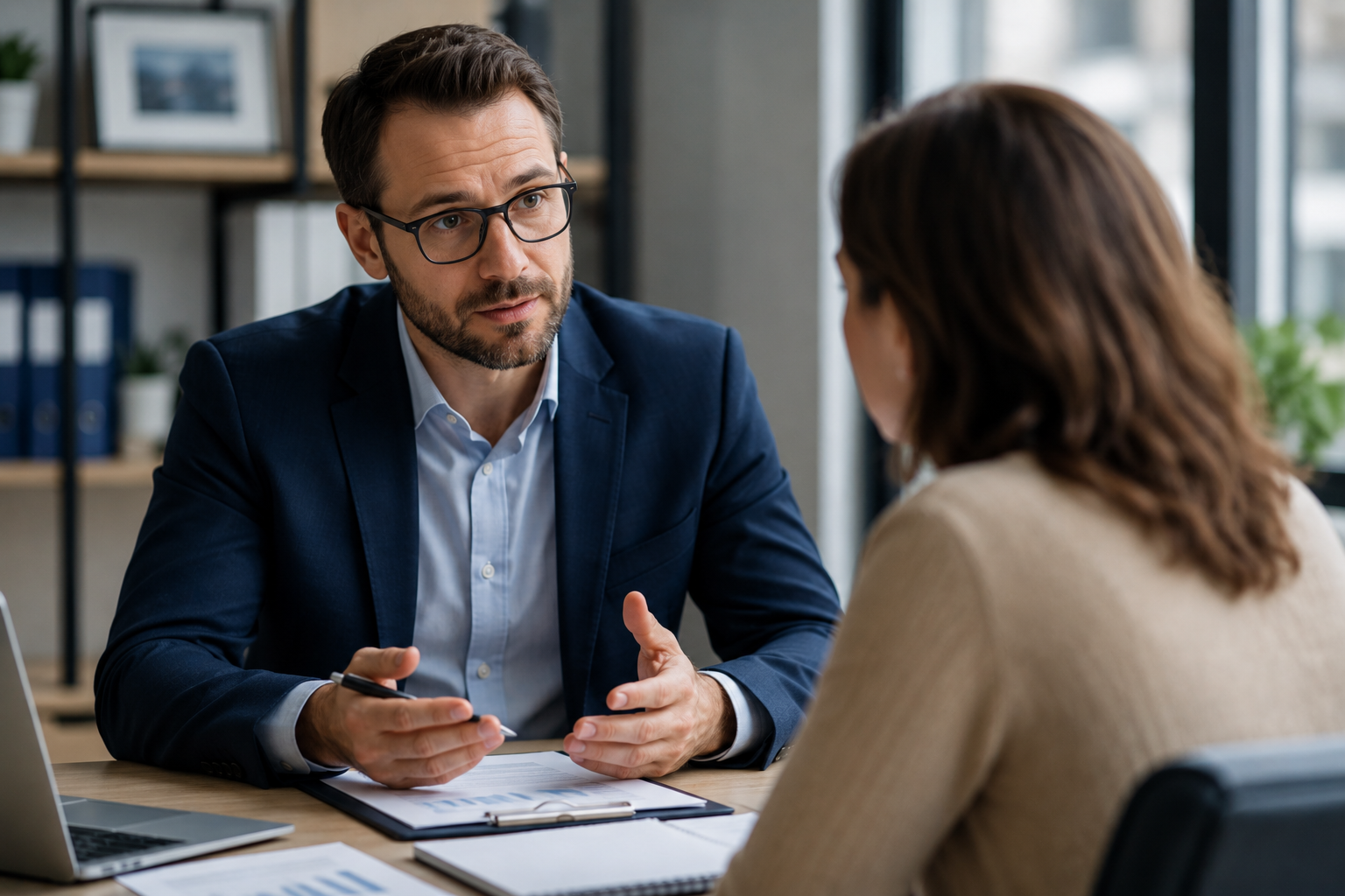 Financial advisor listening attentively to a client during a difficult financial conversation about market uncertainty using calm, empathetic communication.